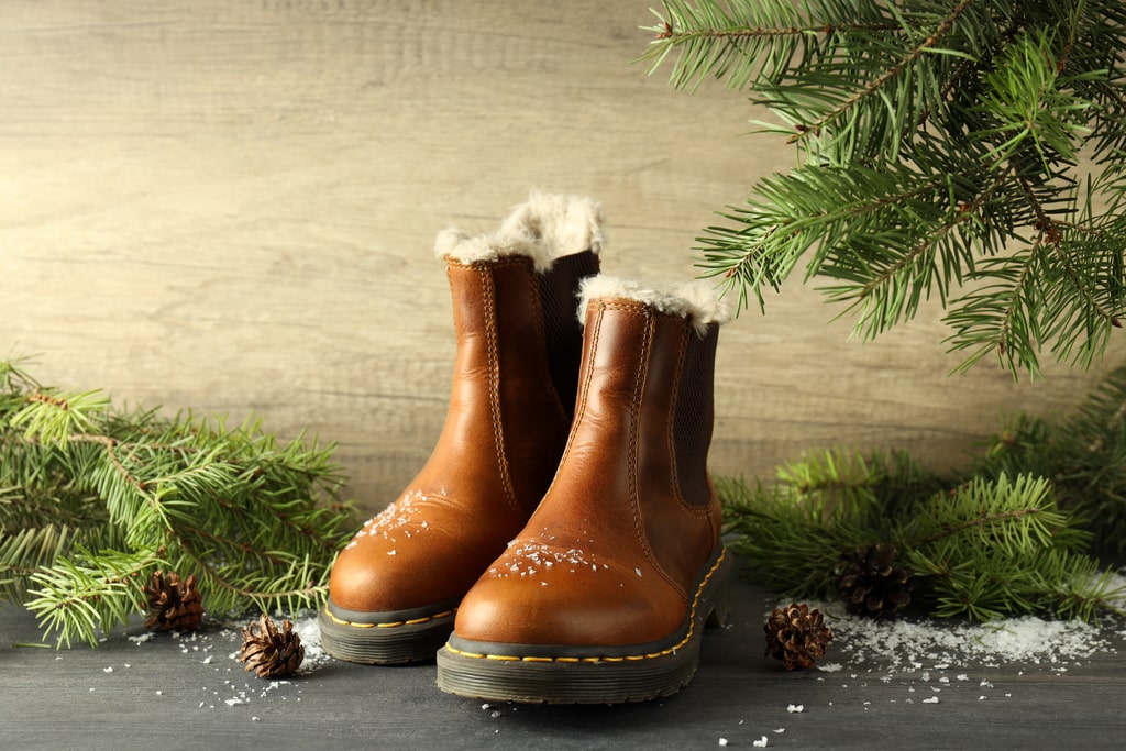 Winter Boots on Dark Wooden Table.